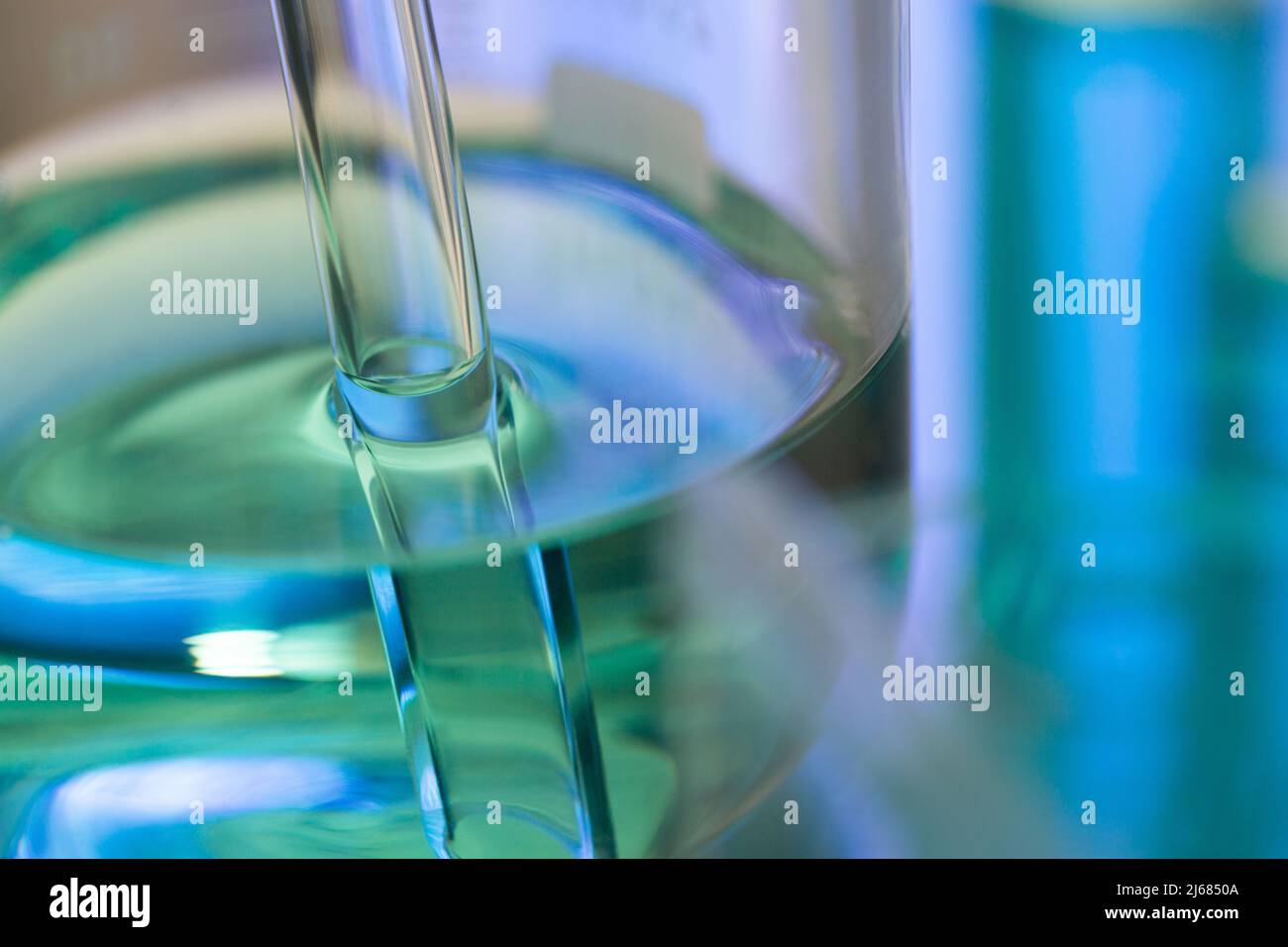 Blue chemical reagent in the beaker with glass pipe - stock photo Stock Photo