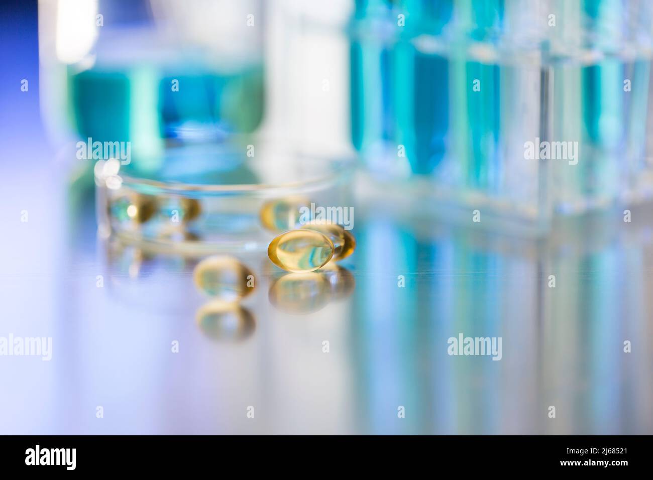 Soft capsules in a chemistry LABS with beaker and glass dish - stock photo Stock Photo