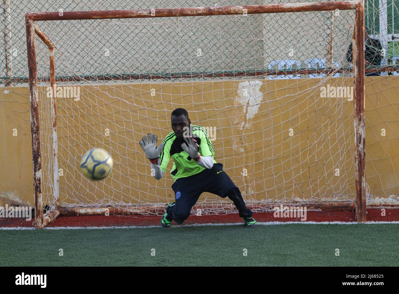 The guard from the Nigerian team tries to stop the ball in Al-Sikt Prison as part of a league for its inmates Stock Photo