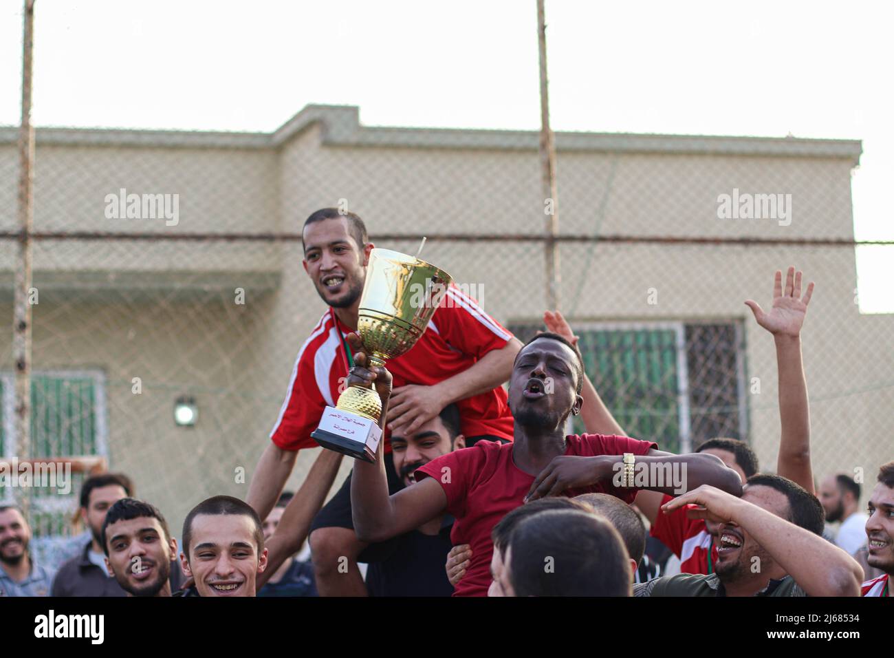 The Libyan team holds the cup after its victory over the Nigerian team in the Ramadan Football League for the inmates of Al-Sakt Prison in Misurata Stock Photo