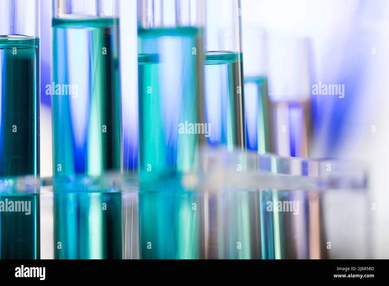 Neatly arranged test tubes containing blue reagent in chemistry laboratory - stock photo Stock Photo
