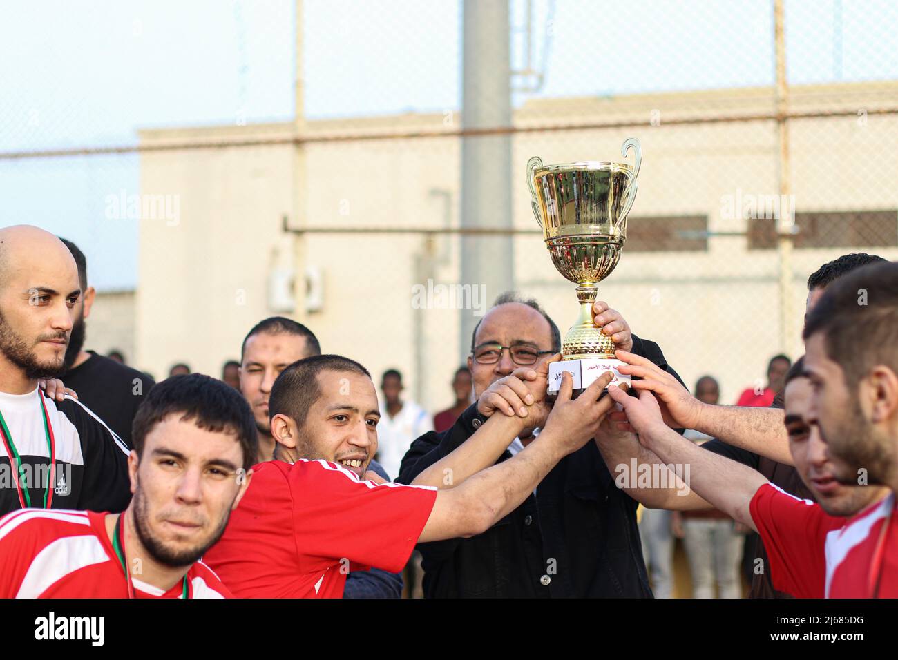 The Libyan team holds the cup after its victory over the Nigerian team in the Ramadan Football League for the inmates of Al-Sakt Prison in Misurata (Photo by Islam Alatrash / SOPA Images/Sipa USA) Stock Photo