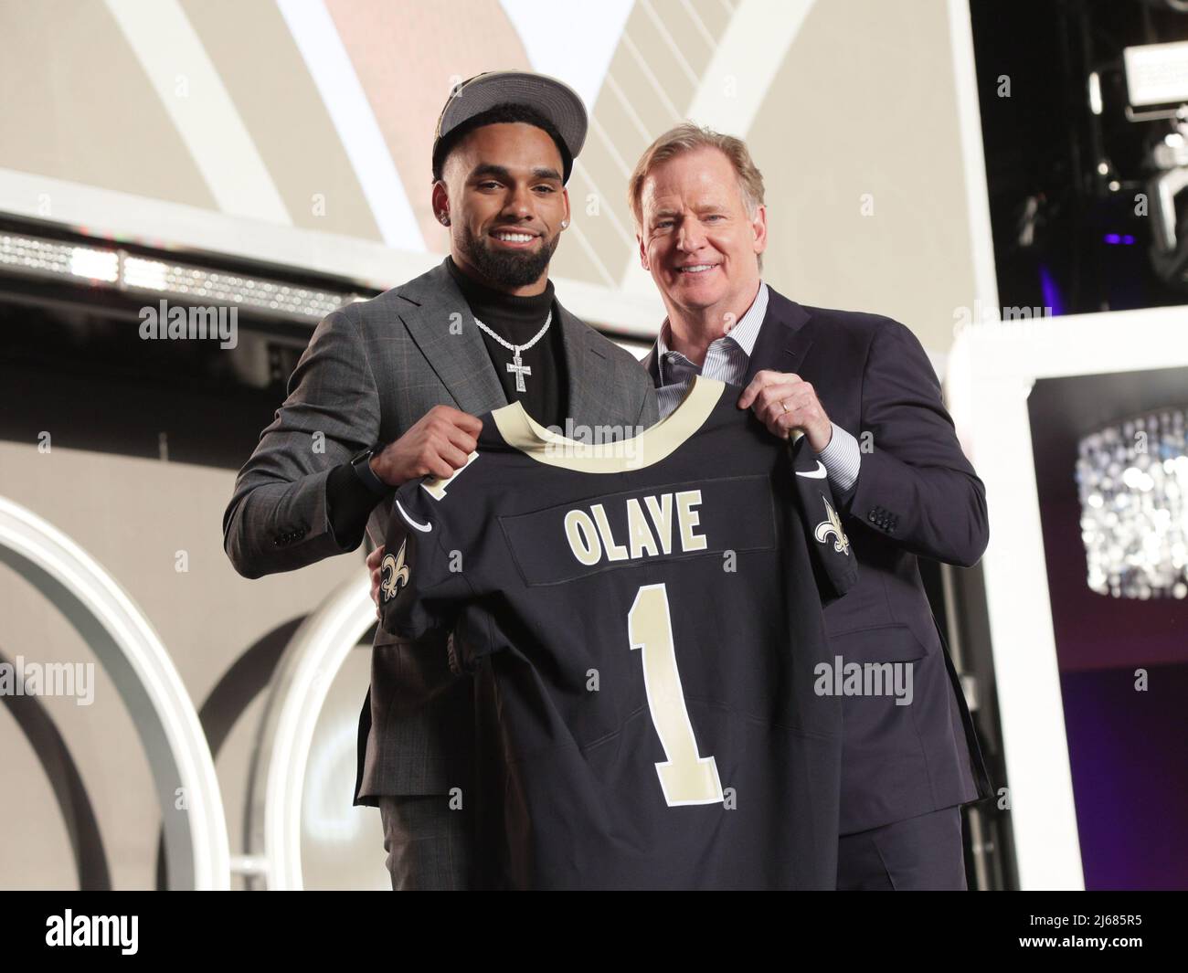 New Orleans Saints wide receiver Chris Olave wears his helmet showing an  American flag, Cuban flag and the Crucial Catch logo before an NFL football  game between the Saints and the Seattle