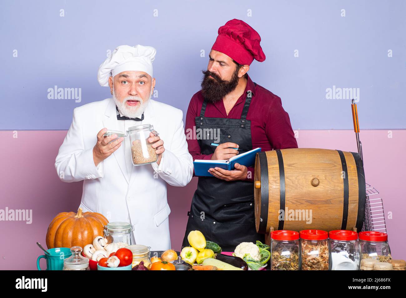 Counter Cook Chef at restaurant kitchen. Male cook wearing apron standing by kitchen ...