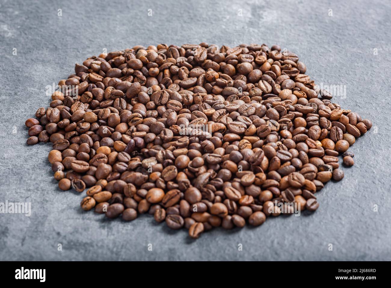 Coffee beans on textured background Stock Photo - Alamy