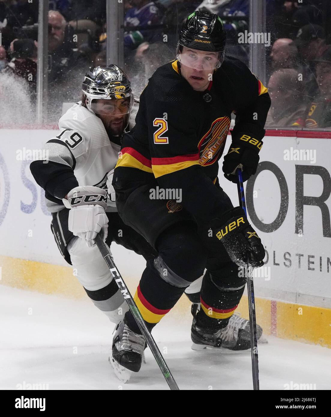 Vancouver Canucks defenceman Luke Schenn (2) and Los Angeles Kings left wing Alex Iafallo (19) battle along the boards for the puck during first period NHL action in Vancouver on Thursday, April