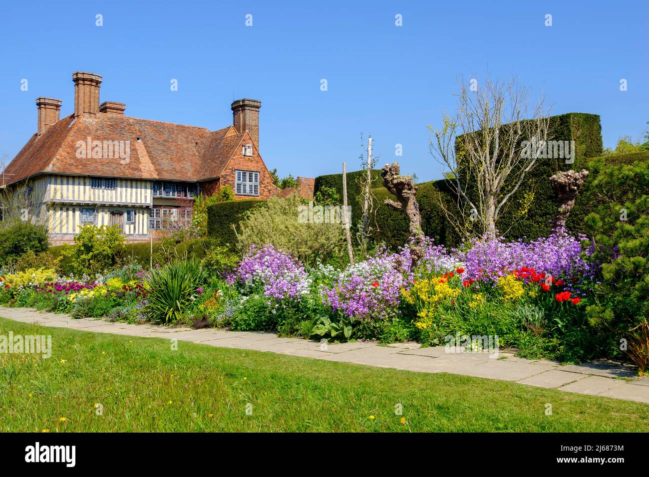The long border in spring at Great Dixter house and garden, East Sussex, UK Stock Photo