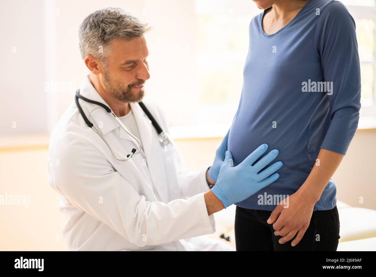 Pregnant Woman At Chiropractor. Baby Breech Physiotherapy And Pregnancy Stock Photo