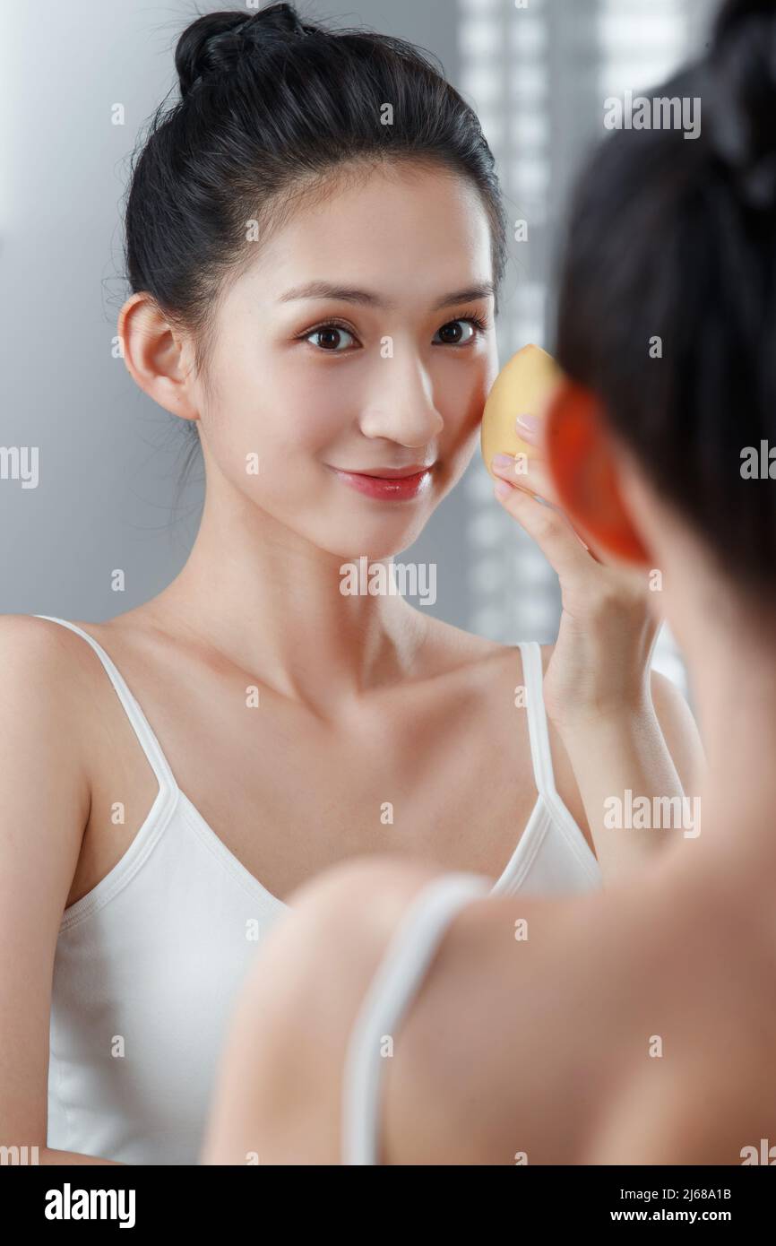 The young woman in the mirror makeup Stock Photo
