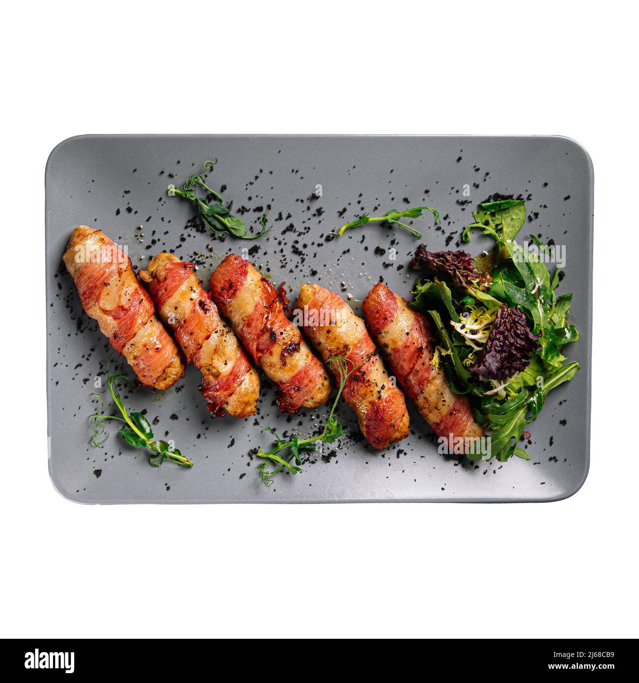 Isolated portion of bacon rolls appetizer on white Stock Photo