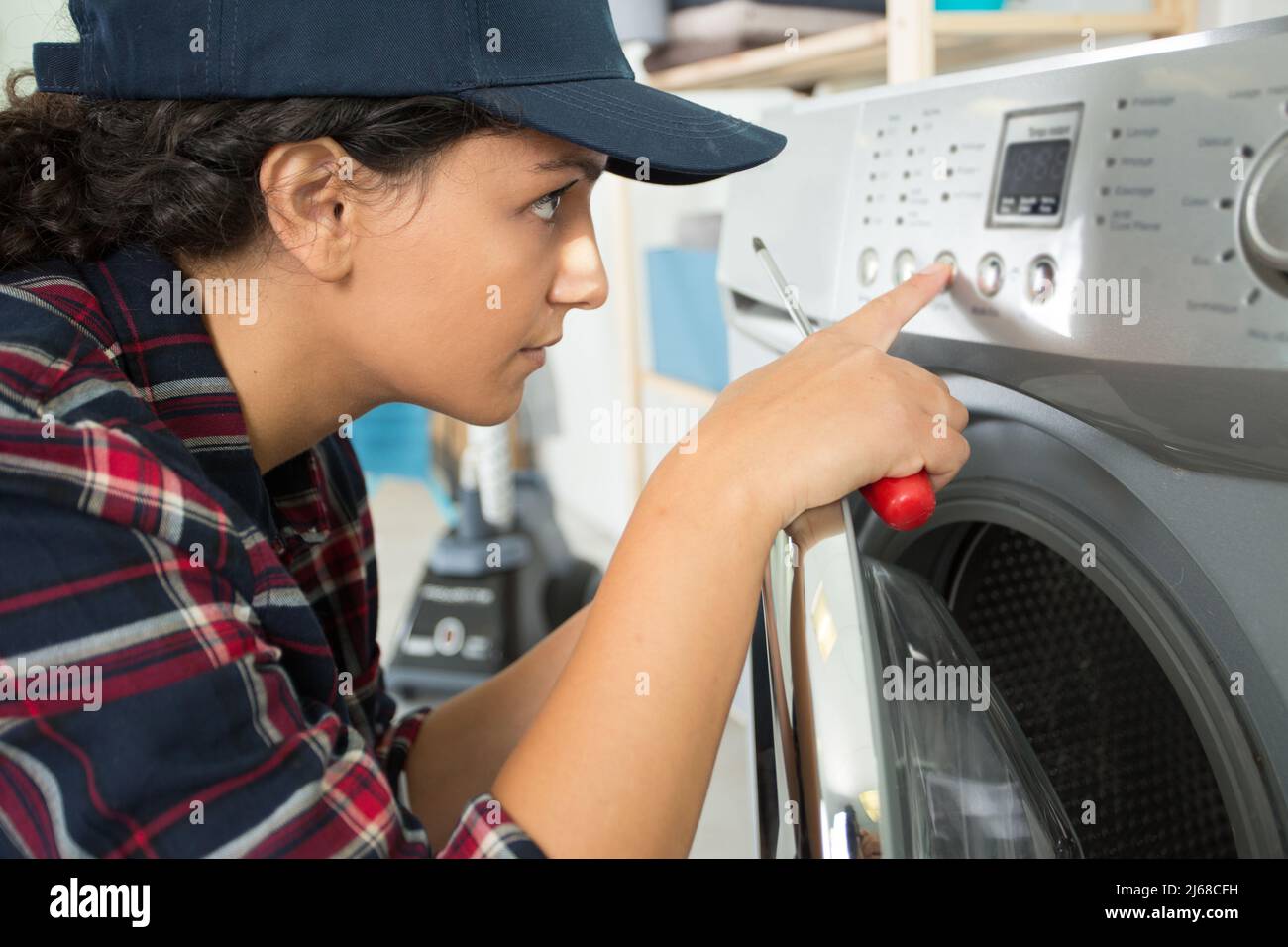 woman has problem with washing machine Stock Photo Alamy