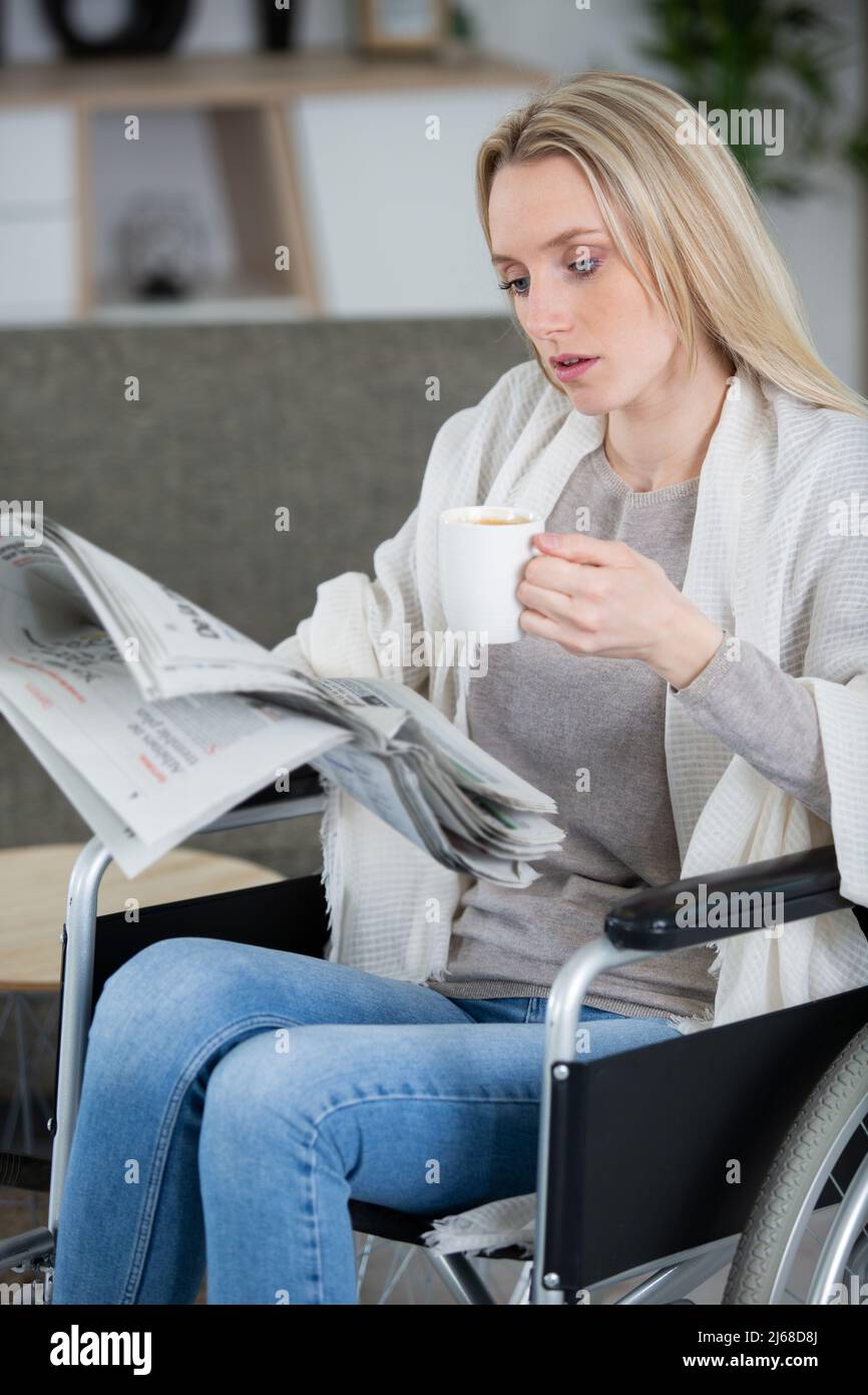 Disabled woman in wheelchair reading hi-res stock photography and ...
