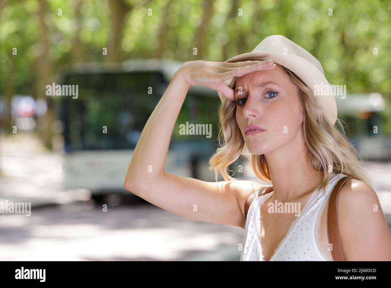 young woman sitting the bus stop Stock Photo Alamy