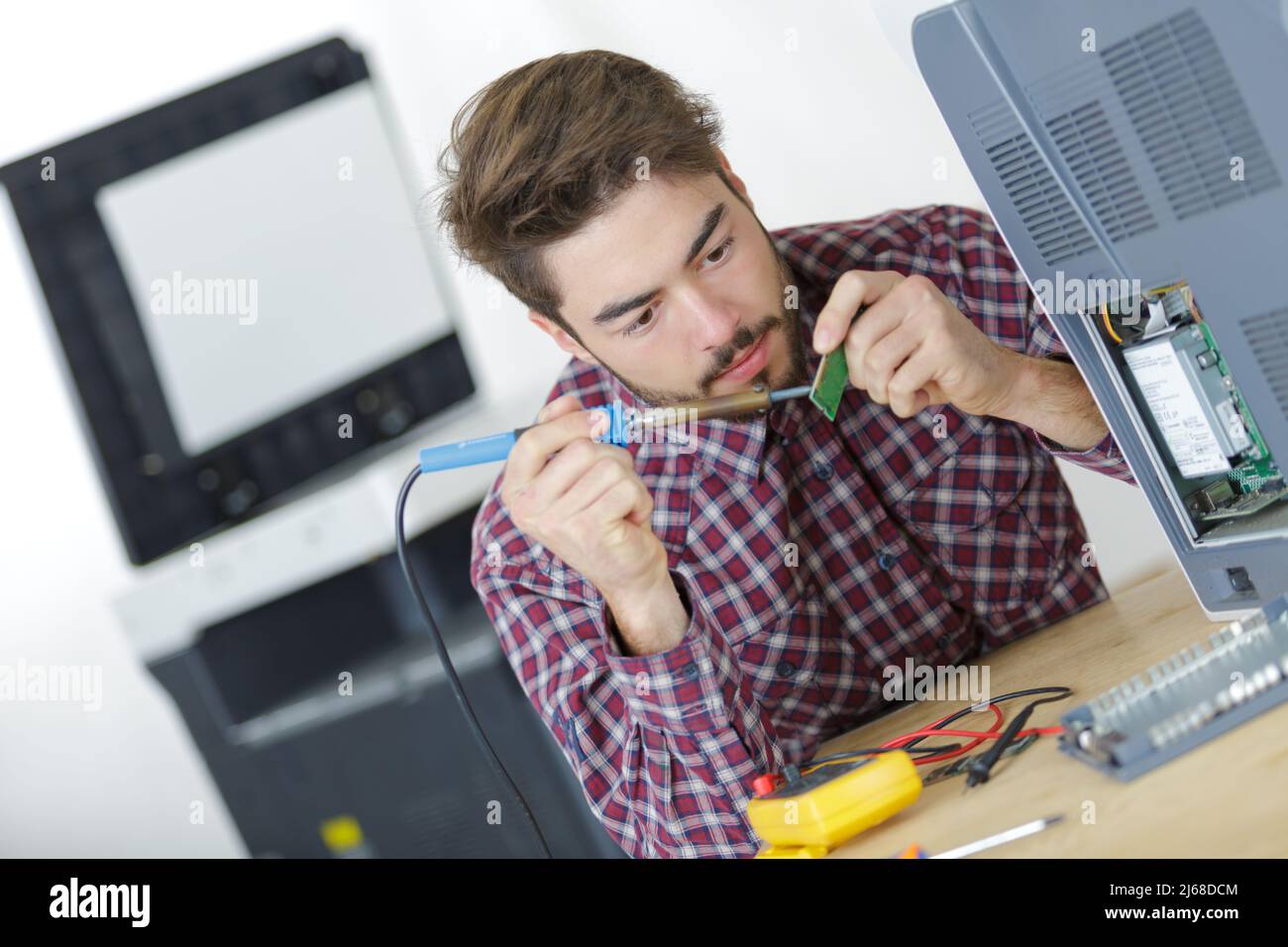 a technician soldering printer cables Stock Photo