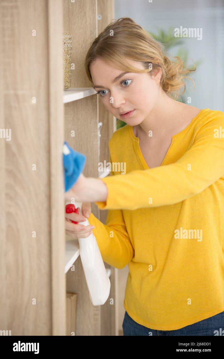 happy concentrated young woman washes a microwave Stock Photo