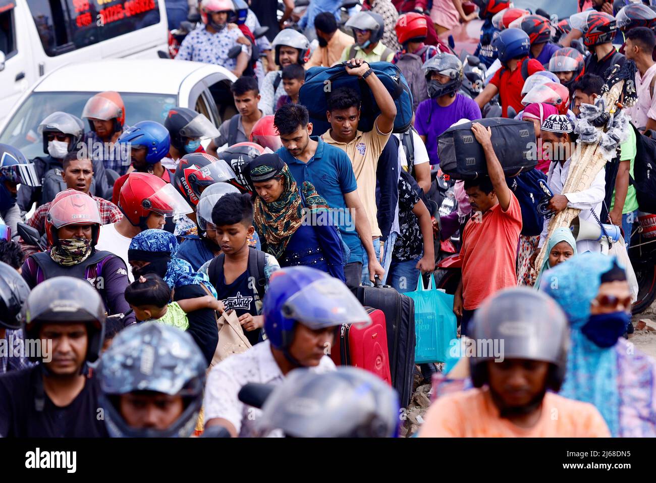 People get into ferries at Bangladesh Inland Water Transport Corporation (BIWTC) Shimulia Ferry Ghat to go home ahead of Eid al-fitr, in Munshiganj, Bangladesh, April 29, 2022. REUTERS/Mohammad Ponir Hossain Stock Photo