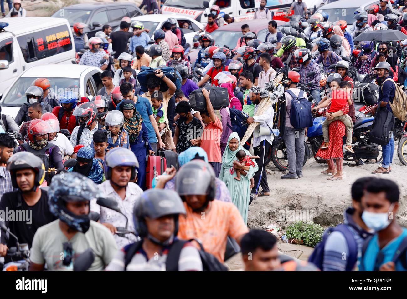 People get into ferries at Bangladesh Inland Water Transport Corporation (BIWTC) Shimulia Ferry Ghat to go home ahead of Eid al-fitr, in Munshiganj, Bangladesh, April 29, 2022. REUTERS/Mohammad Ponir Hossain Stock Photo
