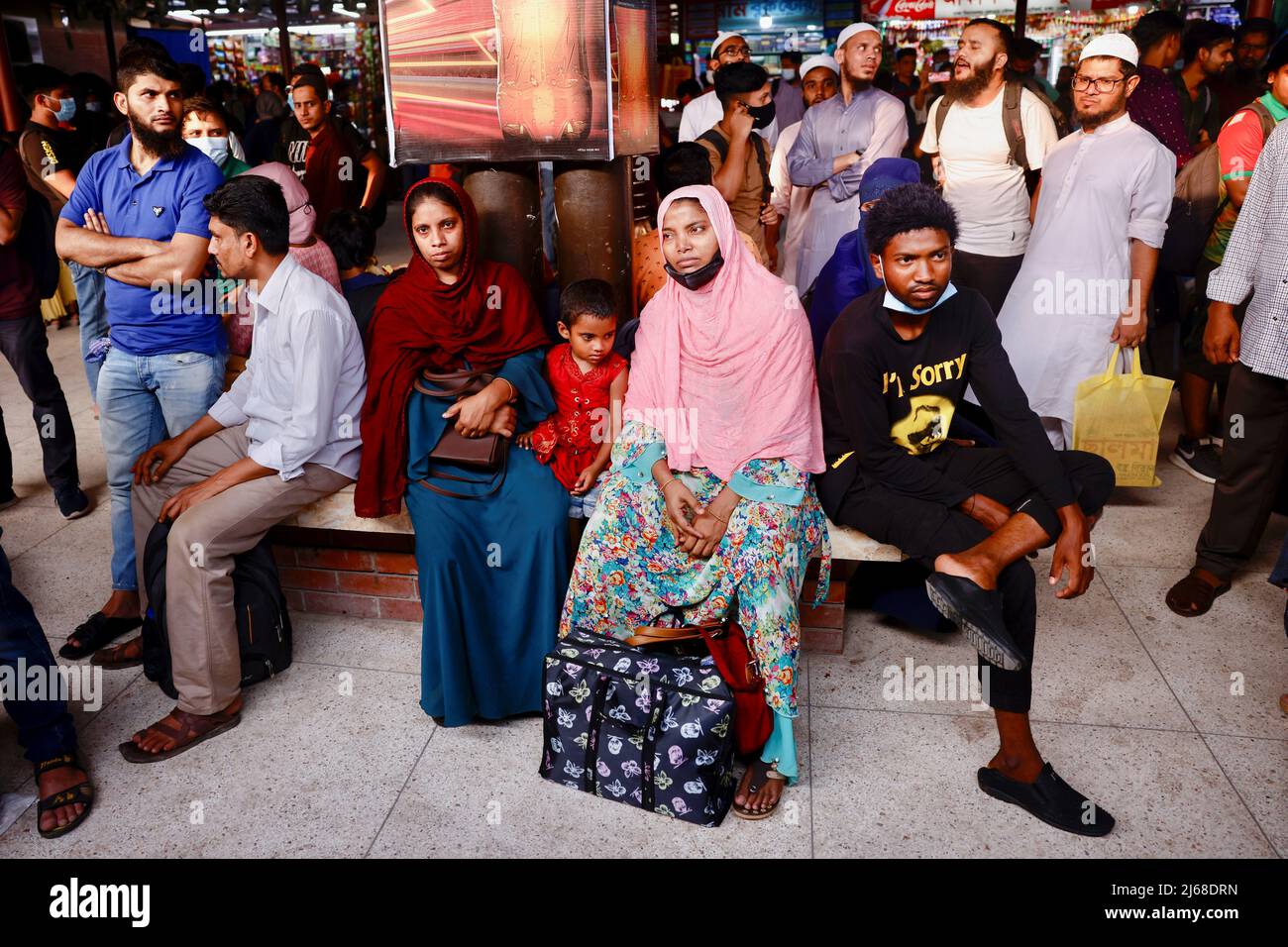 People wait for trains at the Airport Railway Station, to go home ahead of Eid al-fitr, in Dhaka, Bangladesh, April 29, 2022. REUTERS/Mohammad Ponir Hossain Stock Photo