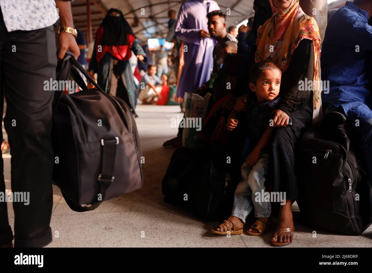 People wait for trains at the Airport Railway Station, to go home ahead of Eid al-fitr, in Dhaka, Bangladesh, April 29, 2022. REUTERS/Mohammad Ponir Hossain Stock Photo