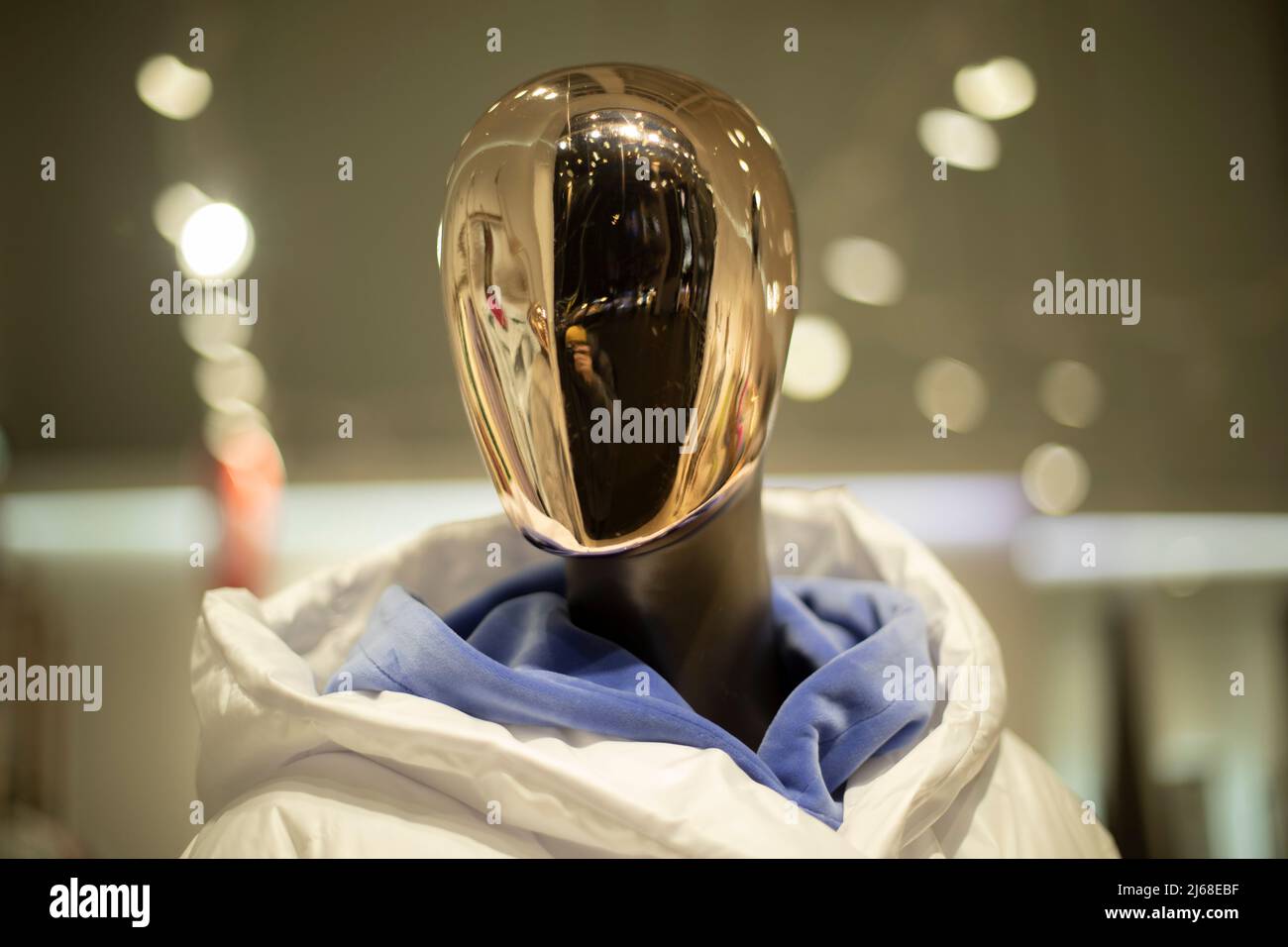 Golden mask on face of mannequin. Details of style and fashion. Mannequin in clothing store. Female figure. Stock Photo