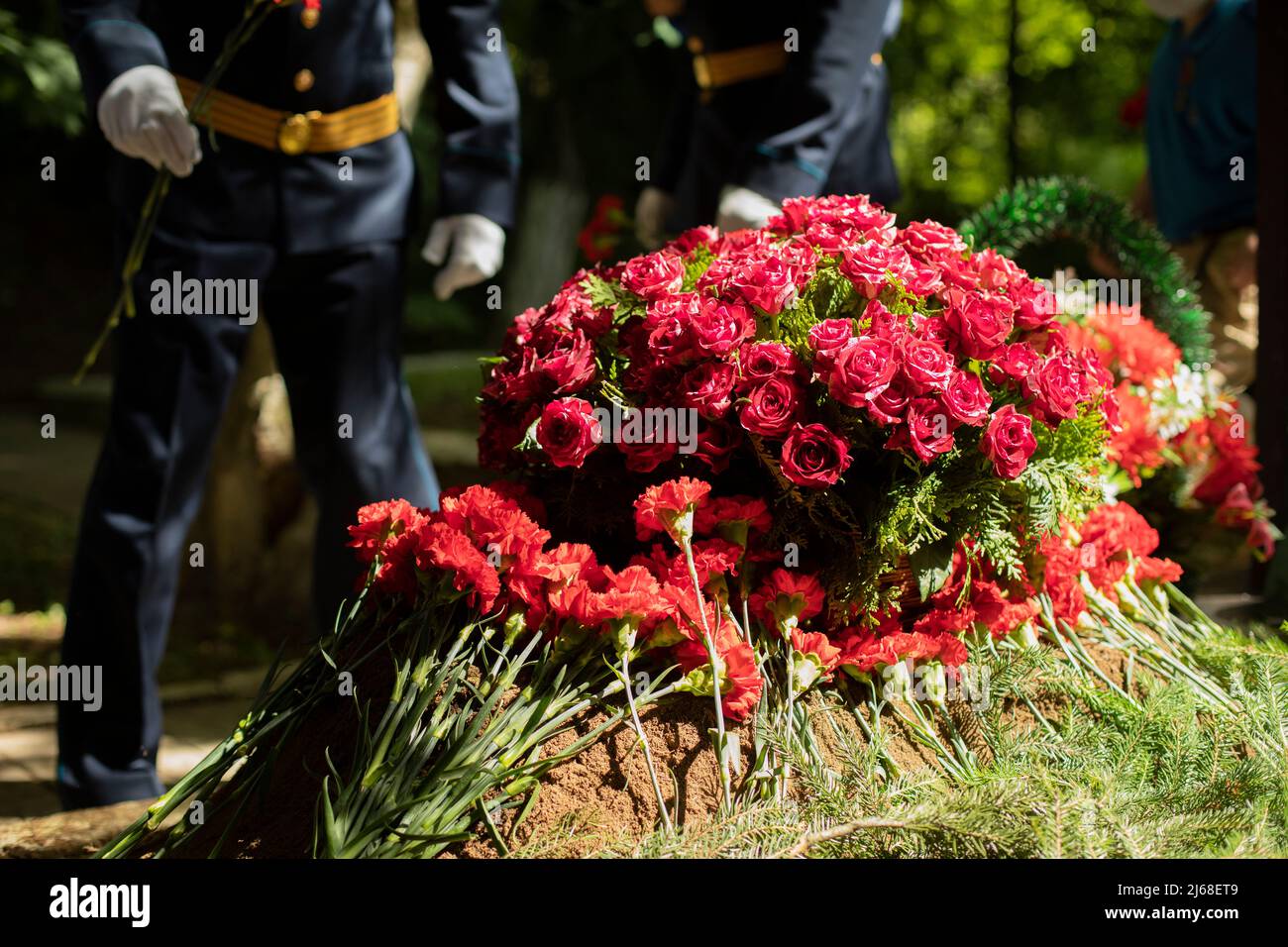 Flowers on grave. Military lay flowers on grave of soldier. Details of