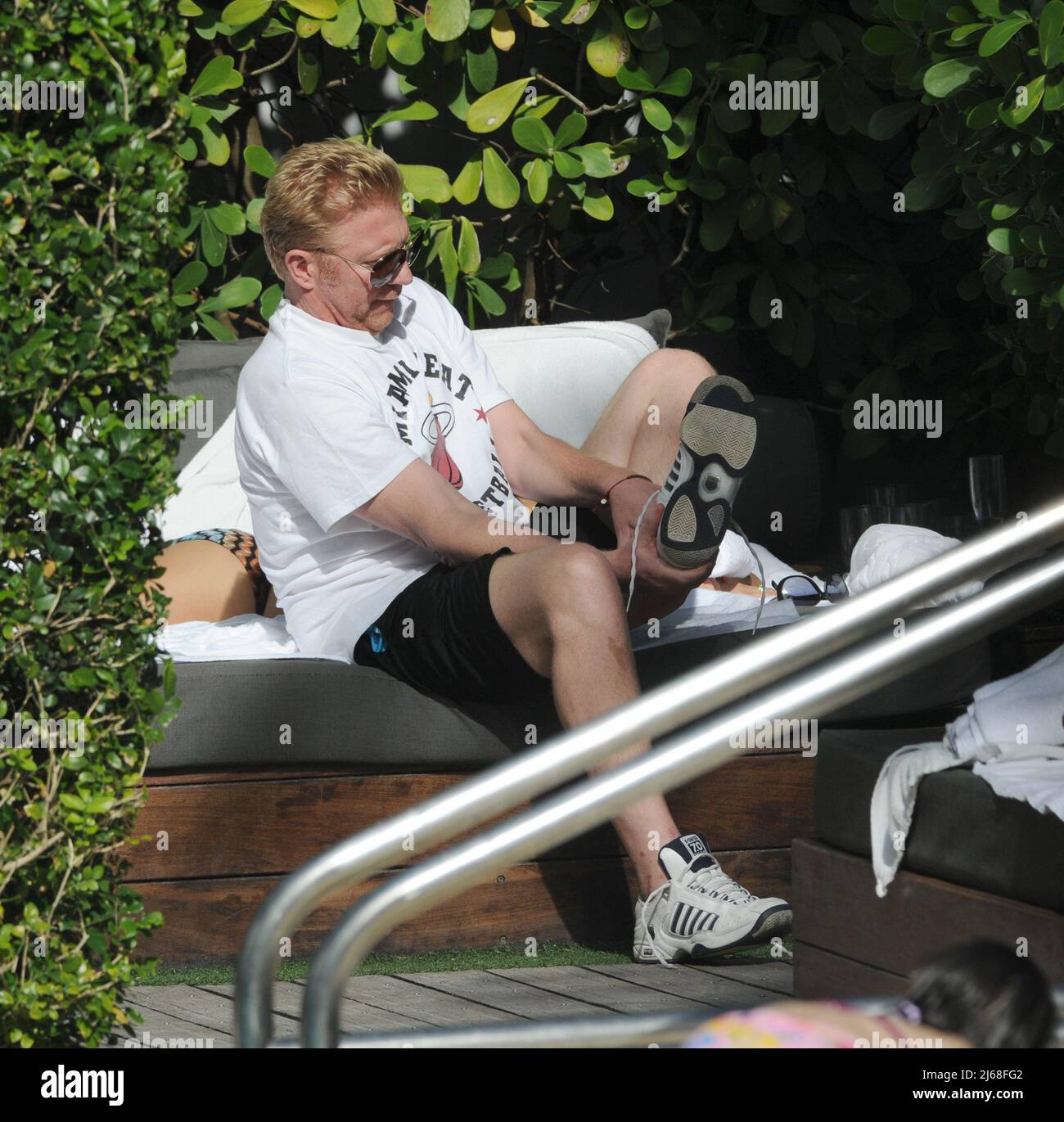 MIAMI BEACH, FL - DECEMBER 21: Tennis great Boris Becker ( AKA Boris Franz Becker)  along with his Wife Sharlely ÔLillyÕ Kerssenberg (model, m. Jun-2009, one son). The former tennis player was spotted relaxing at a hotel in Florida while his wife Sharlely ÔLillyÕ Kerssenberg soaked up the sunshine in a tiny two-piece at their South Beach Hotel.  on December 21, 2011 in Miami Beach, Florida    People:  Boris Becker Sharlely Kerssenberg Stock Photo