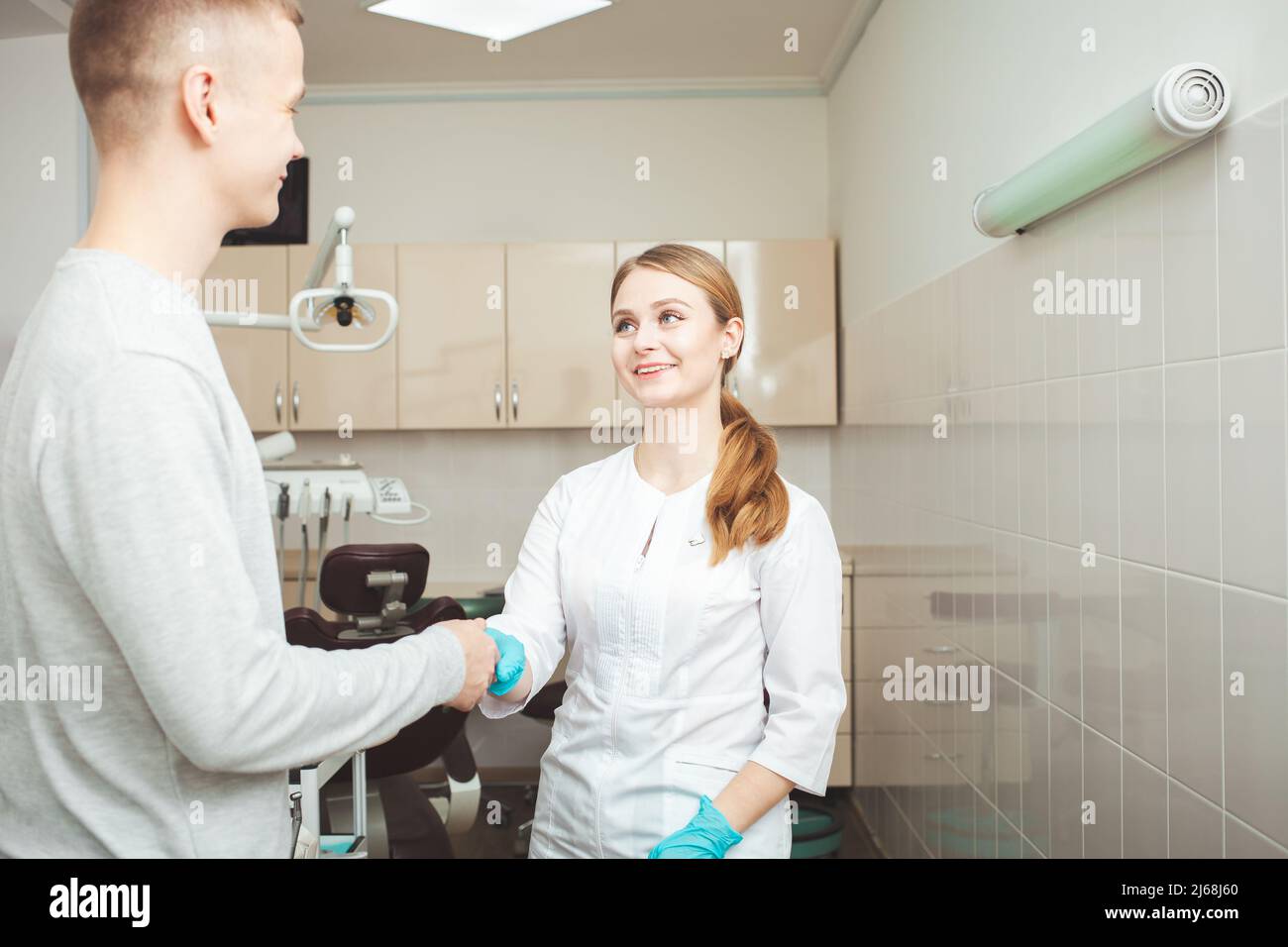 Attractive young female dentist in hi-res stock photography and