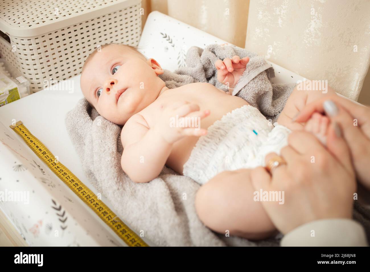 mother measuresh the growth of child, captive table, medical ...