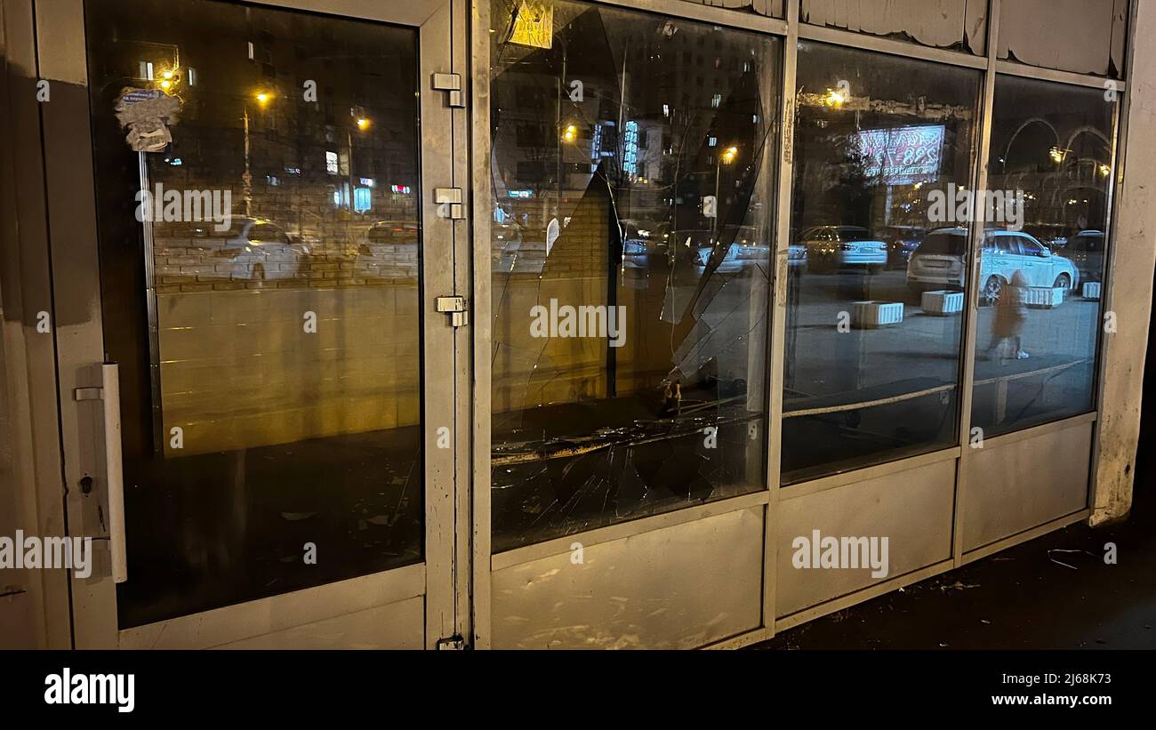 Window with broken glass on city street Stock Photo