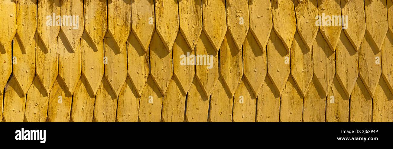 Yellow wooden roof at daytime outdoors, banner Stock Photo