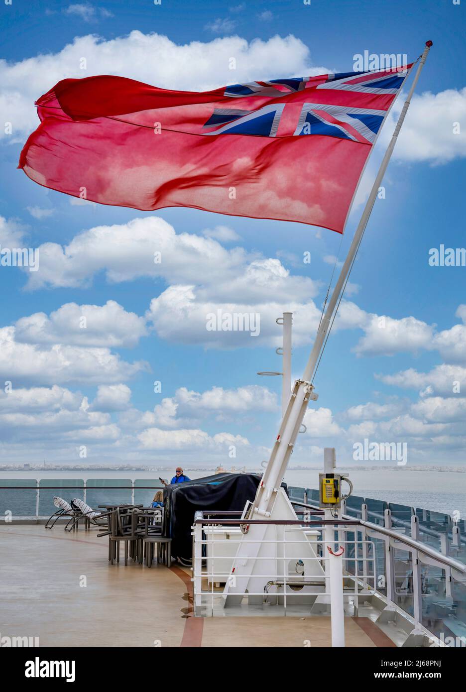 The Red Ensign flag flying on a flagpole attached to the stern of the Cunard ship, RMS Queen Elizabeth Stock Photo