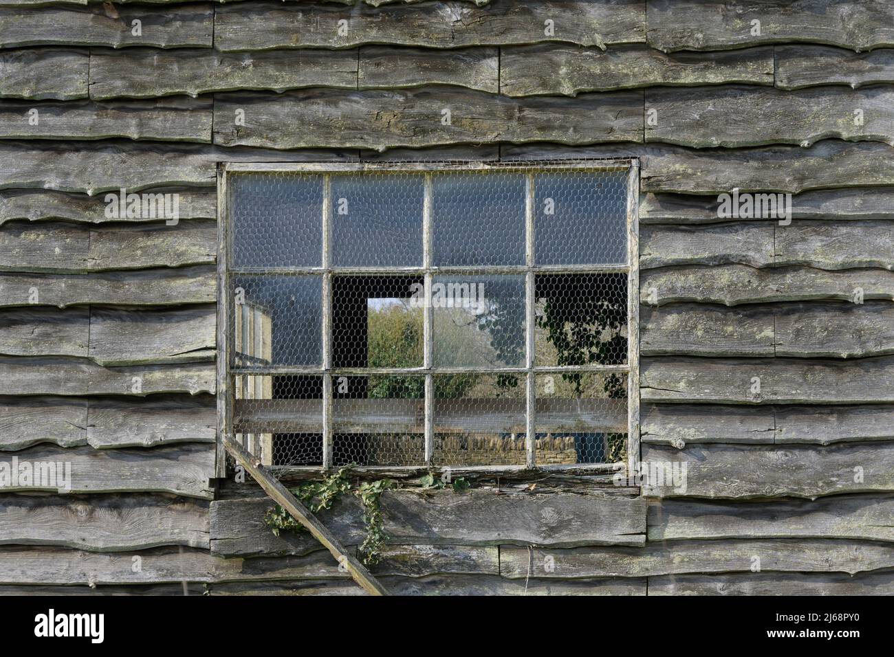 Window of old wooden farm building England UK Stock Photo