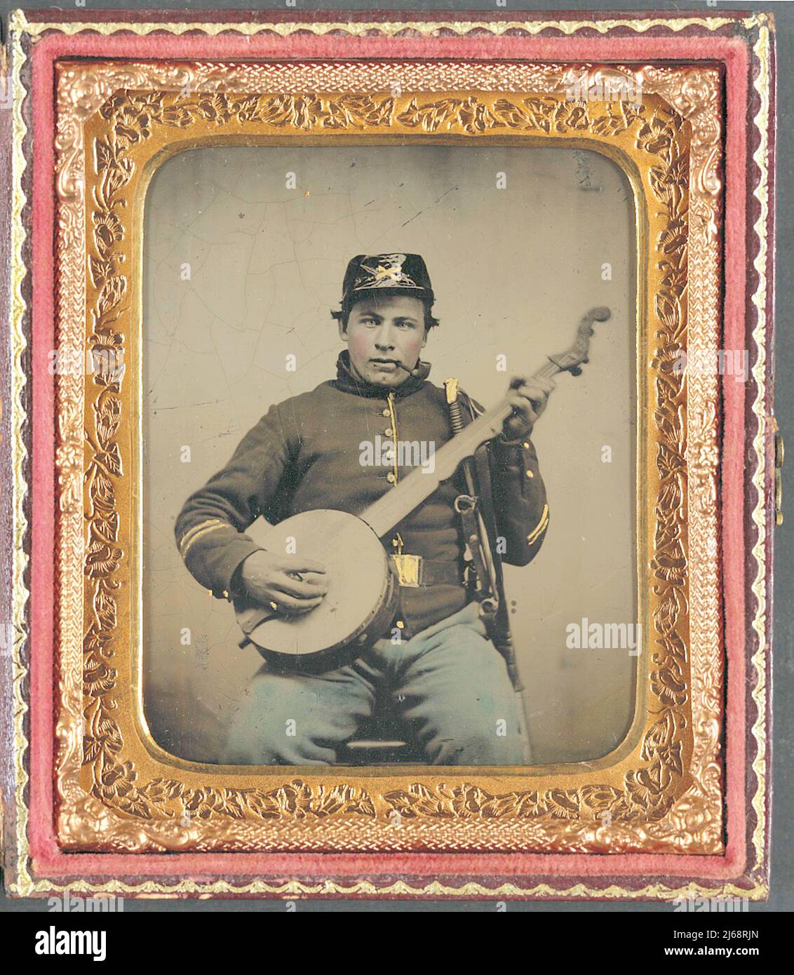 Banjo Player - Unidentified soldier in Union cavalry uniform with banjo, sword and pipe - circa 1862 Stock Photo