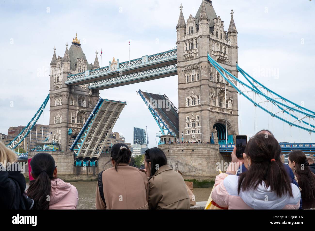 Tourists take photos of London Bridge. Stock Photo