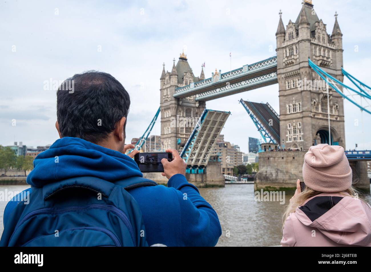 Tourists take photos of London Bridge. Stock Photo