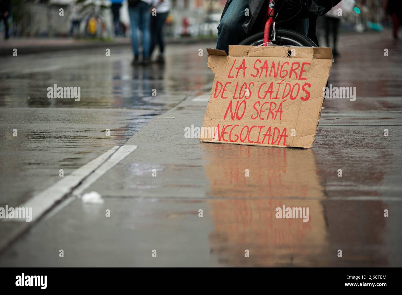 A demonstrator holds a sign that reads 'The blood from the ones fallen will never be negotiated' during the 28 of April commemorative demonstrations a Stock Photo