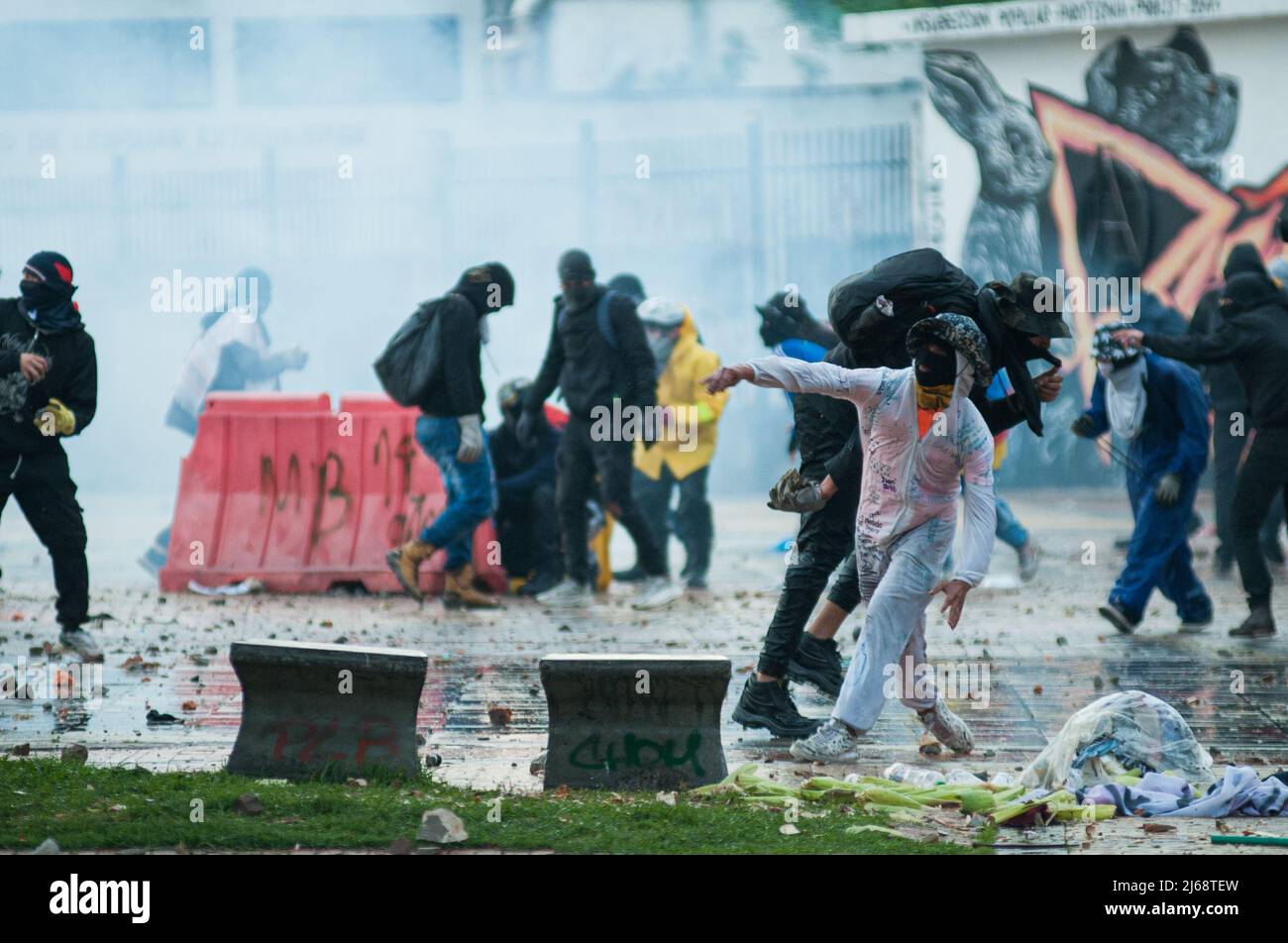 Demonstrators clash with Colombia's riot police 'ESMAD' during the 28 of April commemorative demonstrations against the government of president Ivan D Stock Photo