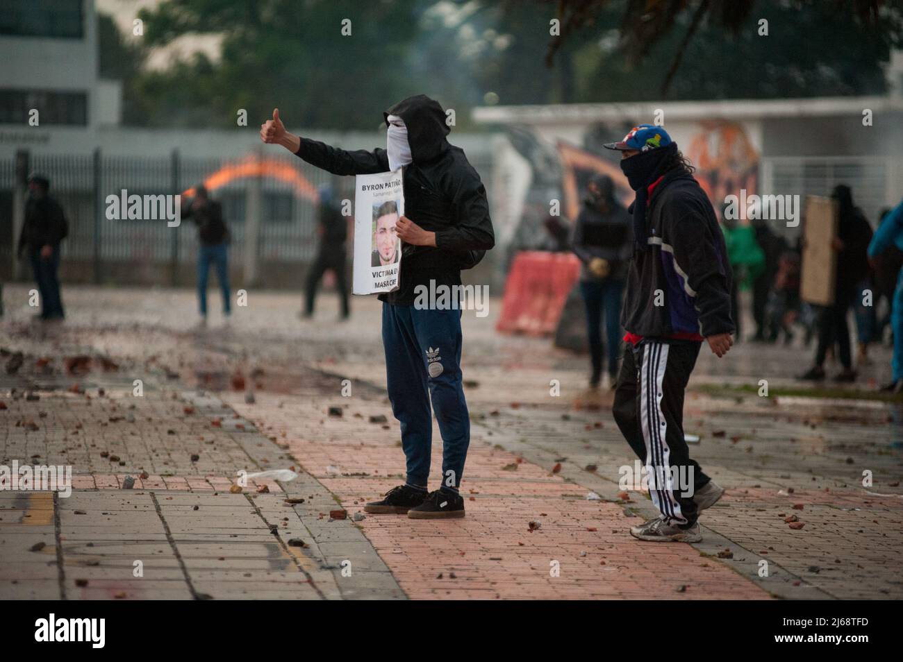 A demonstrators show images of a massacre and police abuse of authority victims during the 28 of April commemorative demonstrations against the govern Stock Photo