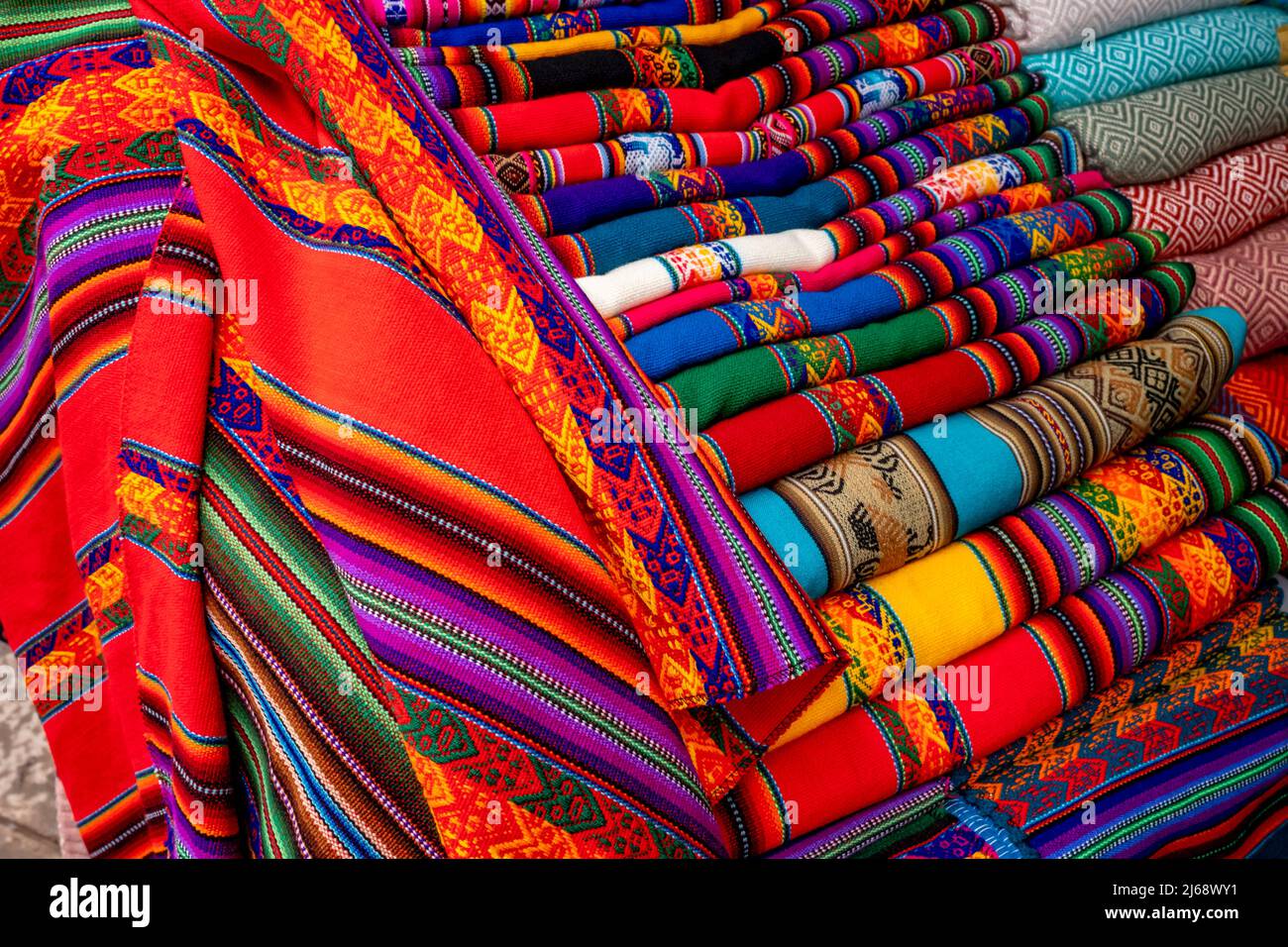 Colourful Shawls/Blankets For Sale In The Market At Pisac, The Sacred Valley, Calca Province, Peru. Stock Photo