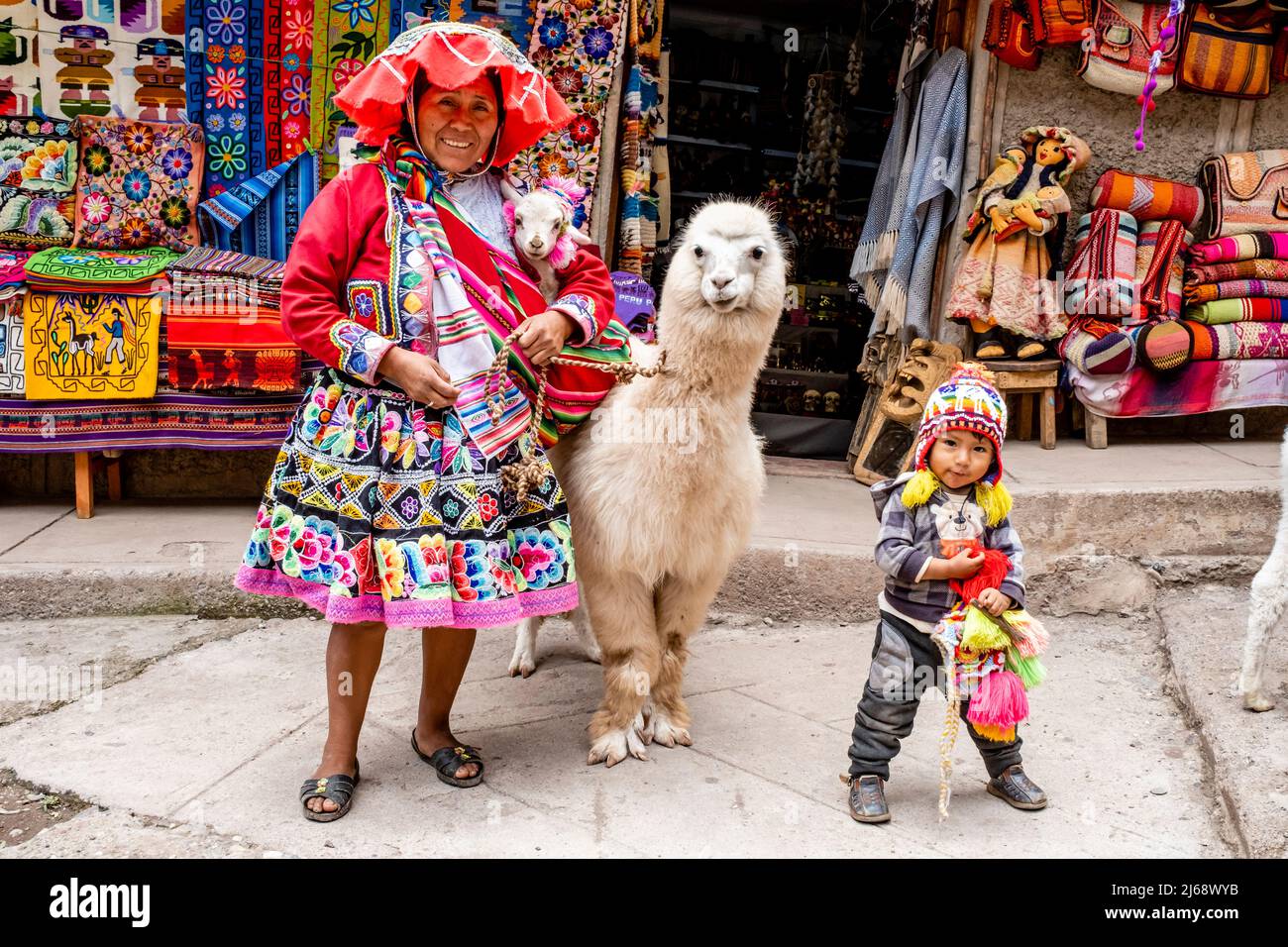 A Woman In Traditional Costume Poses With Her Pet Alpaca In The Town Of  Pisac, The Sacred Valley, Calca Province, Peru Stock Photo - Alamy
