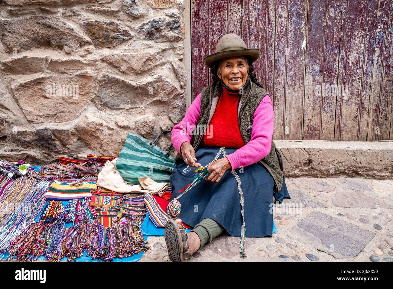 An Indigenous Woman Showing The Traditional Method Of Weaving Wool In The Town Of Pisac, The Sacred Valley, Calca Province, Peru. Stock Photo