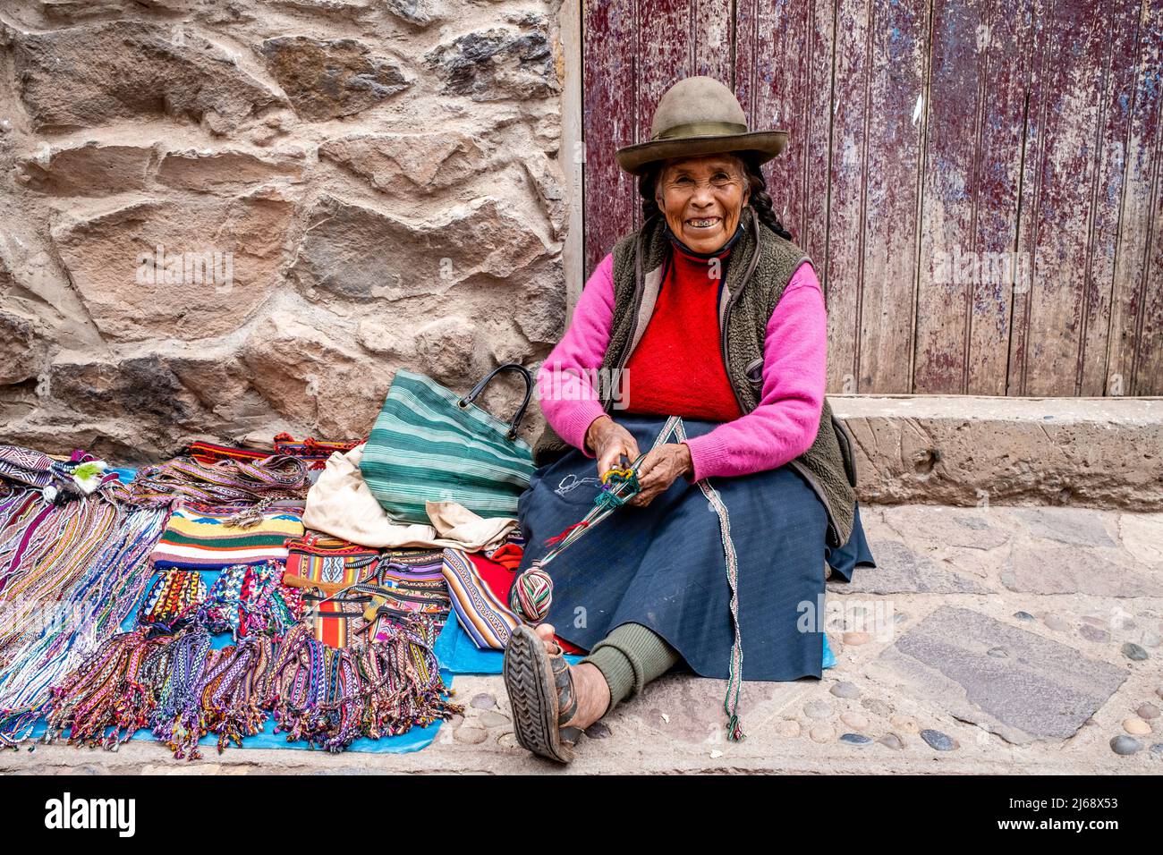 An Indigenous Woman Showing The Traditional Method Of Weaving Wool In The Town Of Pisac, The Sacred Valley, Calca Province, Peru. Stock Photo