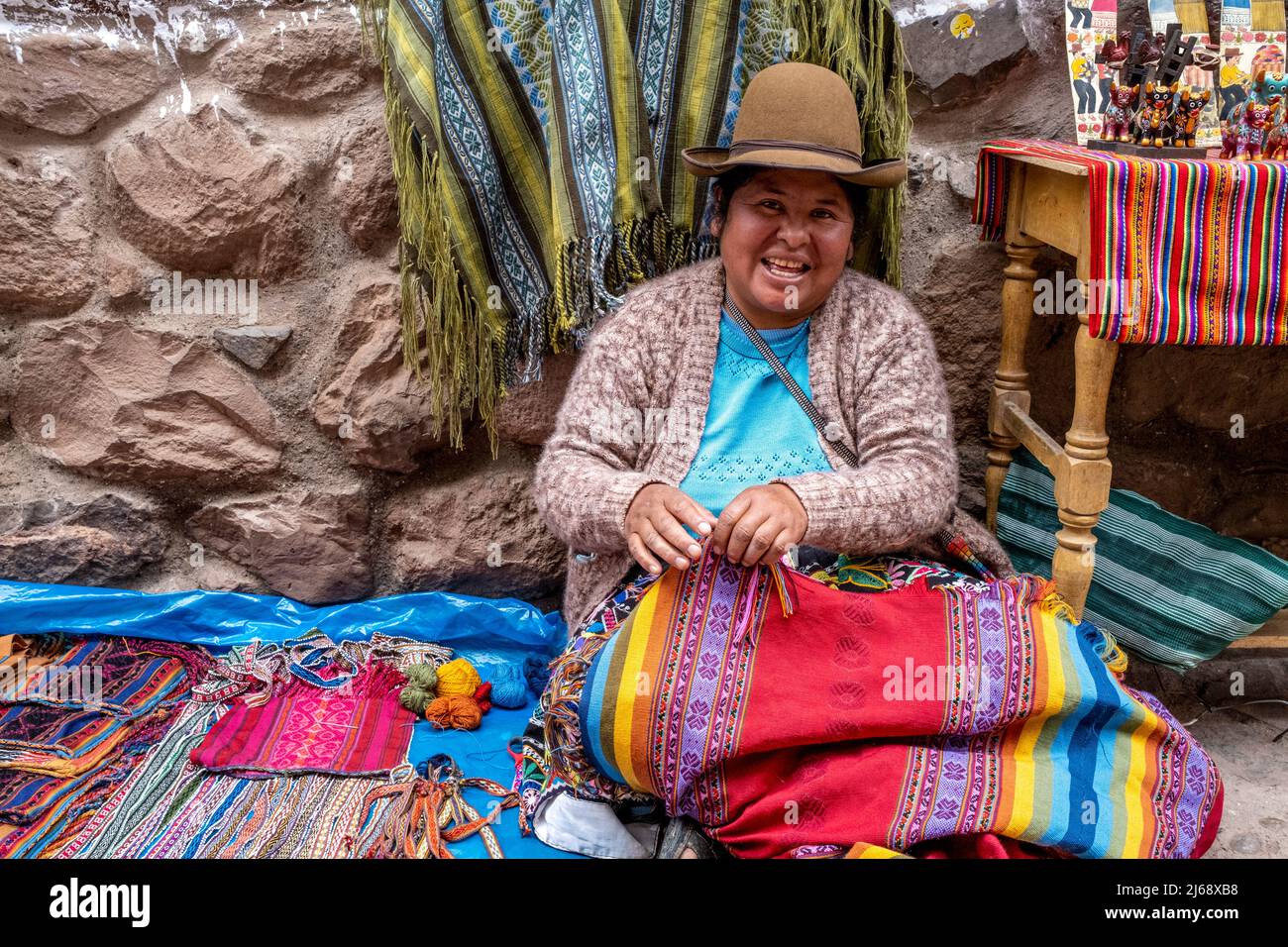 An Indigenous Woman Displays Her Hand Made Souvenirs/Crafts At The Sunday Market In The Town Of Pisac, The Sacred Valley, Calca Province, Peru. Stock Photo