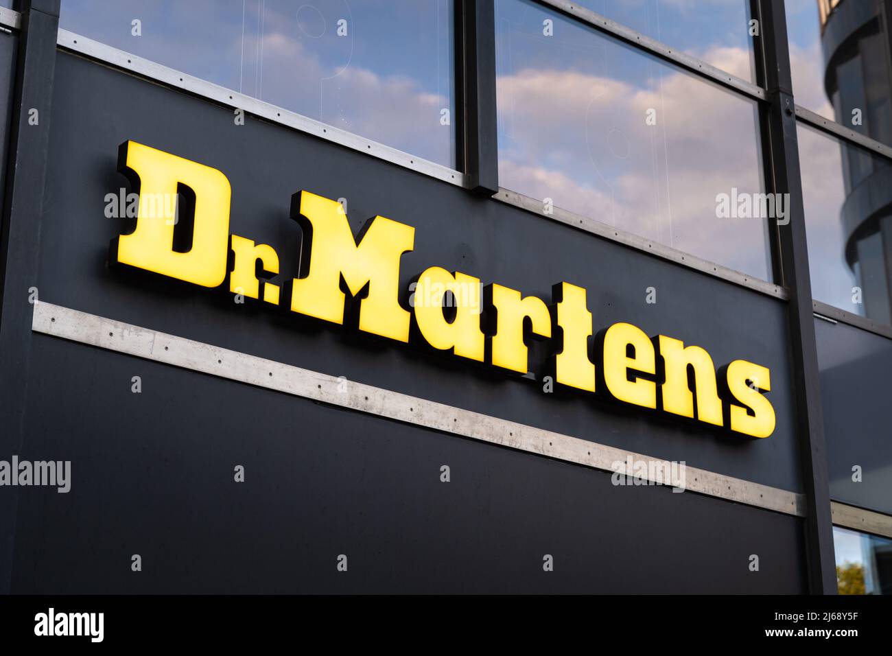 Dr. Martens store in the city. Big yellow illuminated lettering on the  front of the shop. International company brand logo. Boutique in Berlin  Stock Photo - Alamy