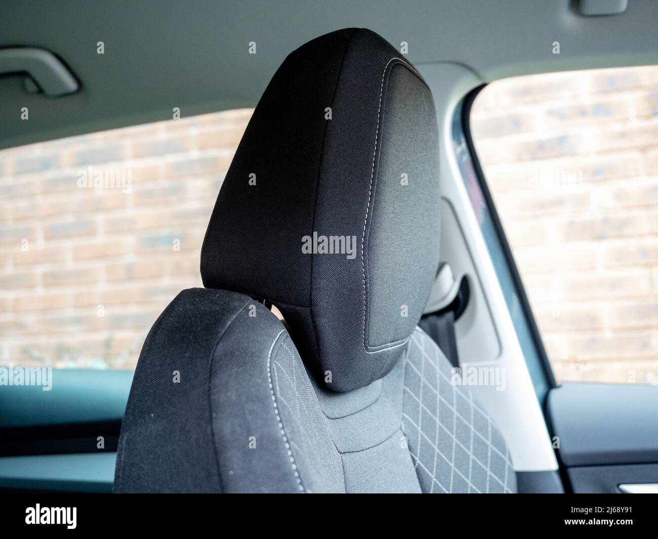 black fabric stitched cloth car headrest in upmarket sports utility vehicle Stock Photo