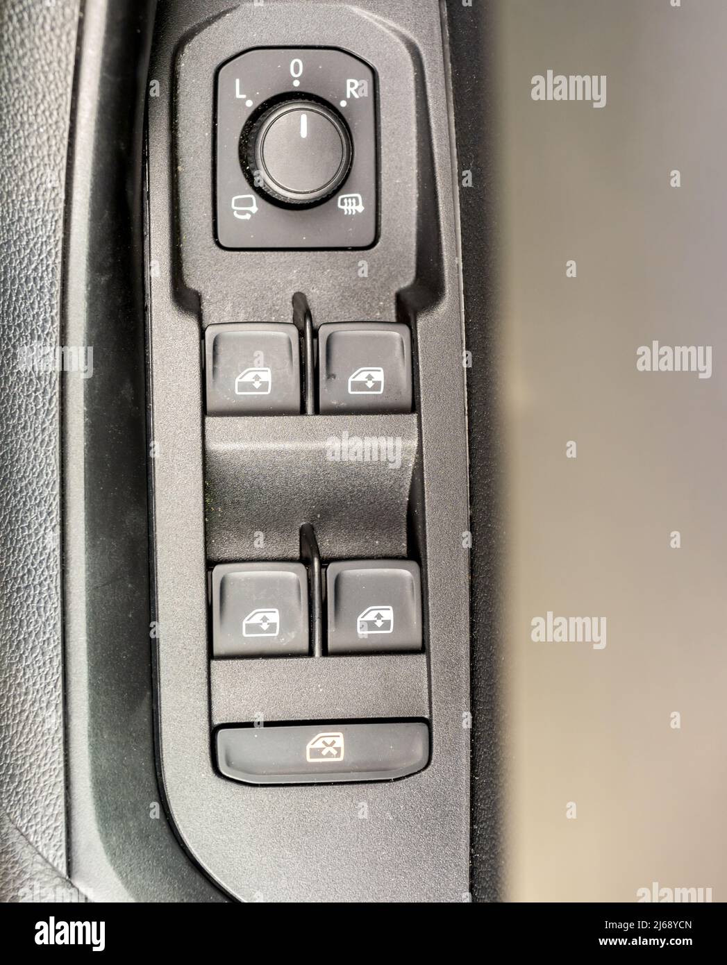 Car door cluster of dials and switches for windows mirrors and central