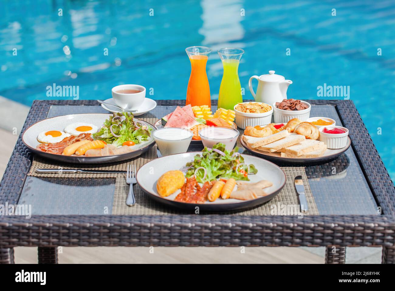 American breakfast near swimming pool, exotic food at luxury hotel resort Stock Photo