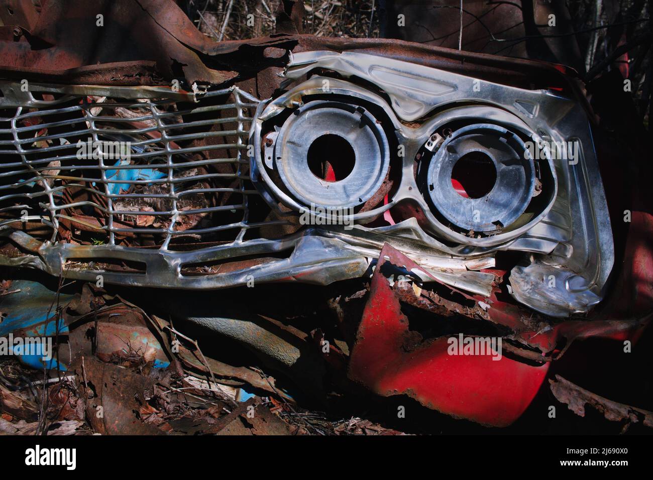 Wrecked vintage auto headlight housing resembling evil eyes Stock Photo