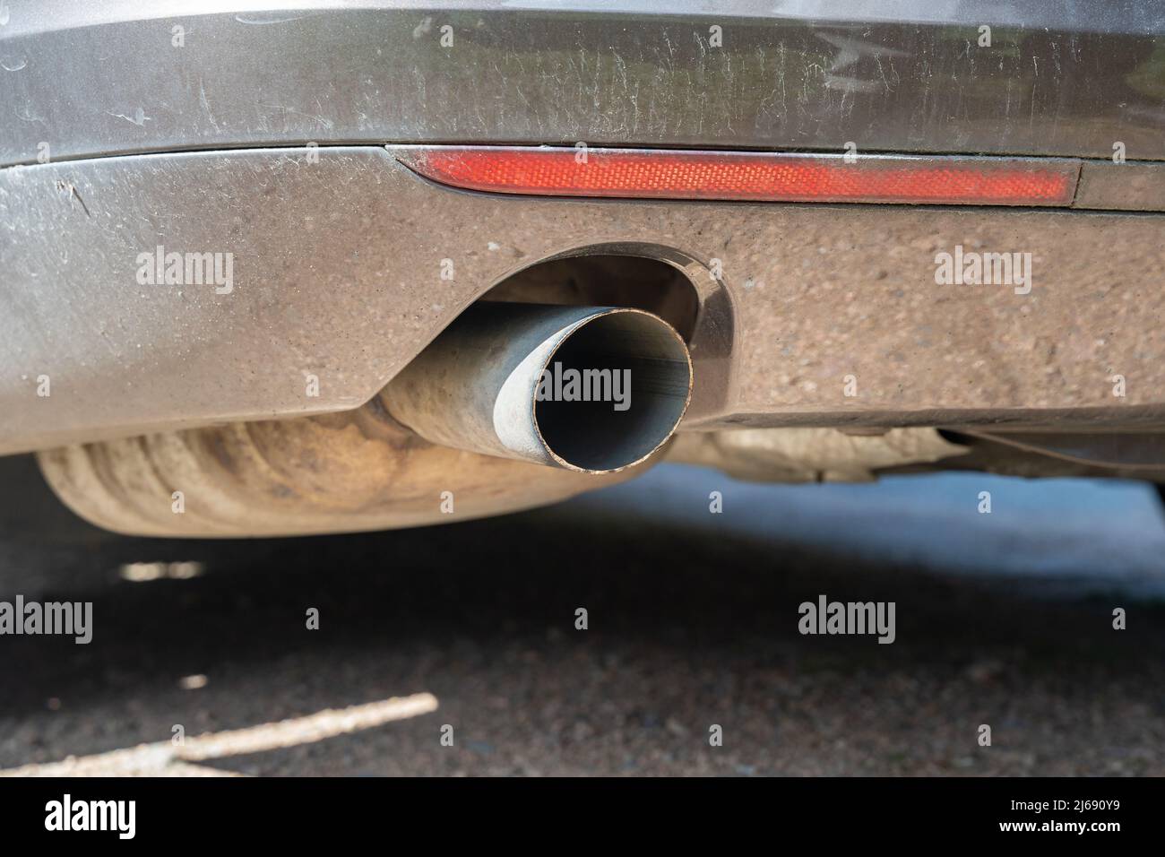 Exhaust pipe of a car closeup. Environmental pollution due to