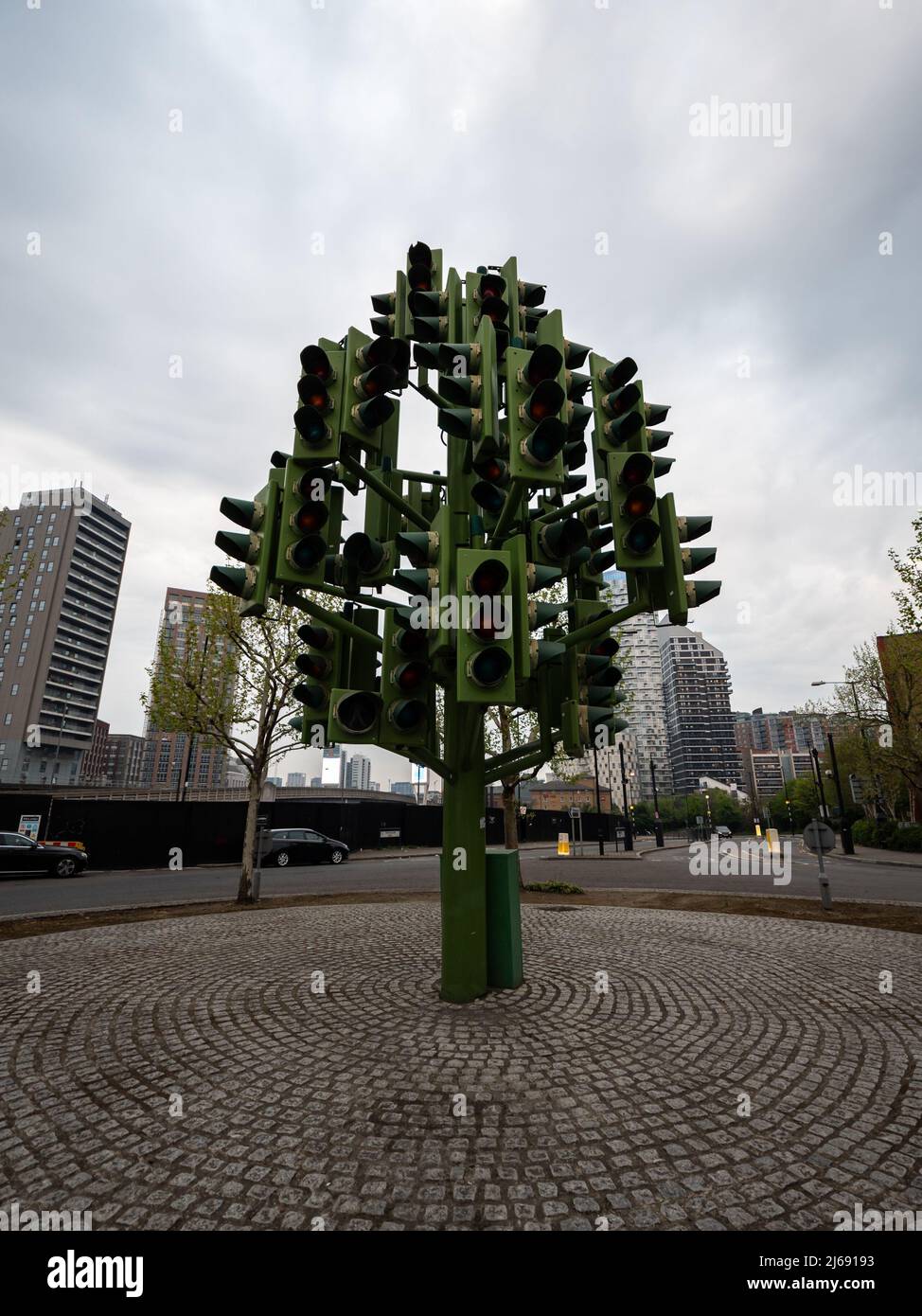 Traffic Light Tree attraction in Canary Wharf on daytime. Modern art in the city on a cloudy overcast day. Sculpture in public. Stock Photo